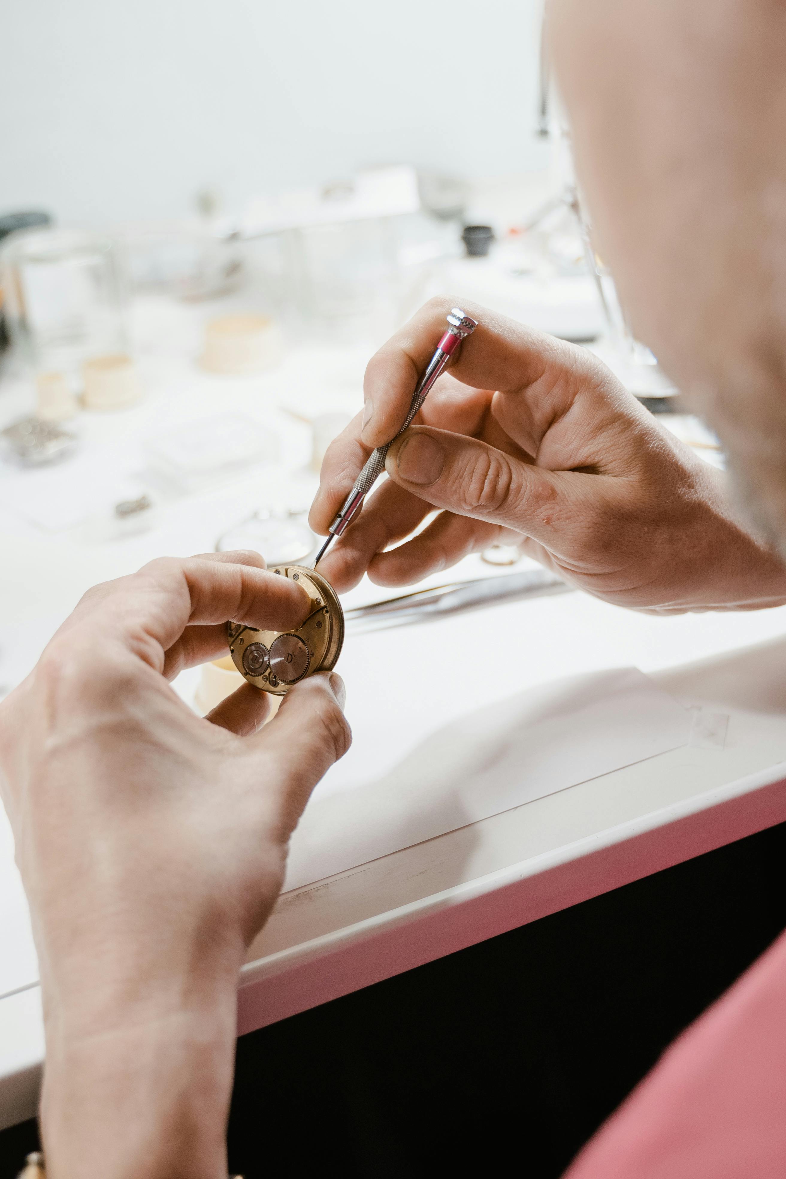 Mechanische Armbanduhr im Uhrenatelier mit offenem Werk in Kupfer und Smaragd
